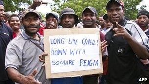 Protesters hold a placard during a friendly demonstration in Port Moresby, 15 Dec 2011