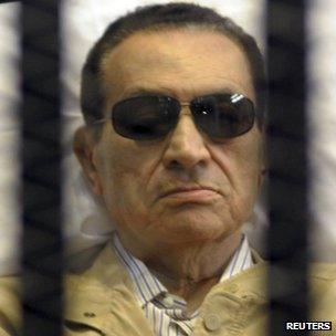 Hosni Mubarak sits inside a cage in a courtroom in Cairo. Photo: 2 June 2012