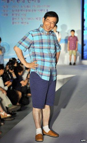 Seoul's mayor Park Won-Soon (C) wears shorts on a catwalk to help promote a casual clothing campaign