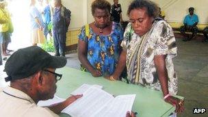 Voters names are checked in Kokopo, East New Britain province, Papua New Guinea, 23 June