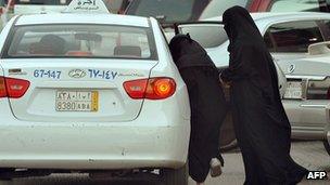 Saudi women get into a taxi outside a shopping mall in Riyadh on June 22, 2012