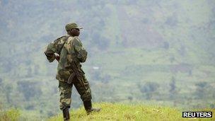 A Congolese government soldier stands guard at a military outpost between Kachiru village and Mbuzi hill, in eastern Democratic Republic of the Congo, May 25, 2012.