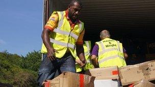 Menzie Yere loading donated kit