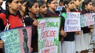 Indian schoolgirls holding placards during a protest against female foeticide