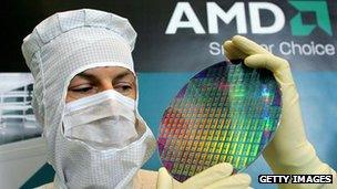 AMD engineer holds up silicon wafer