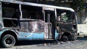 Burnt-out bus seen in the Damascus district of Qabun on 22 July 2012