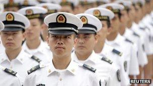 Chinese People's Liberation Army (PLA) navy sailors stand in a line and wait to attend a ceremony at the Great Hall of the People in Beijing, 19 July, 2012