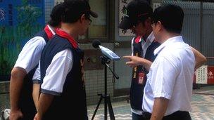 Inspectors from Taipei's Department of Environmental Protection read a sound level meter in Taipei, Taiwan, 16 July 2012