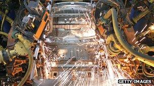 Robots weld a car at a GM plant in Michigan