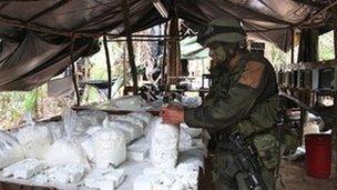 Laboratory table piled with bagged cocaine, Colombia
