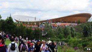 Fans in the Olympic Park walk near the velodrome during day six of the Games