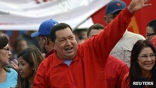 Venezuela's President Hugo Chavez's (C) greets supporters during an election rally in the low-income neighbourhood of Antimano in Caracas August 3, 2012.