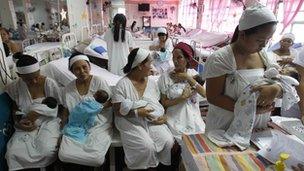 Women holding babies in maternity ward of Jose Fabella hospital