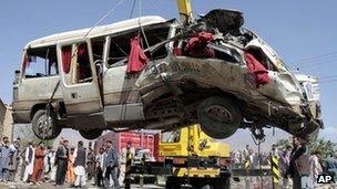 Bus wreckage being lifted by a crane