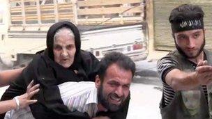 An elderly woman is moved from her home in Aleppo (7 Aug 2012)
