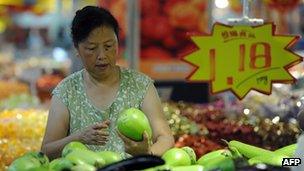 A consumer buying vegetables in China