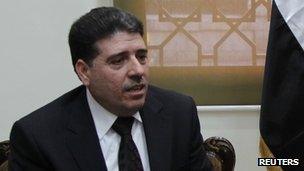 Syrian Health Minister Wael al-Halqi sits at his office in Damascus, April 3, 2012