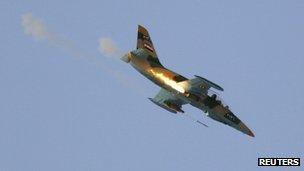 A Syrian Air Force fighter plane fires a rocket during an air strike in the village of Tel Rafat, some 37 km (23 miles) north of Aleppo, August 9, 2012