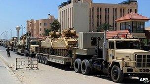 Trucks carrying tanks in al-Arish