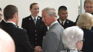 Prince Charles speaking to rescuers and flood victims