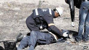 Injured policeman is treated after riot at Lonmin mine. 13 Aug 2012