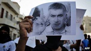 A Bahraini Shiite Muslim youth holds a picture of prominent rights activist Nabeel Rajab during a protest in June 2012