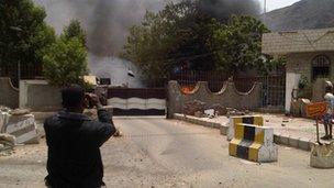 Smoke rises from the intelligence building in Aden, Yemen