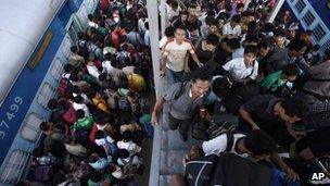 Indians get off a train originating in Bangalore in Gauhati, Assam's main city.