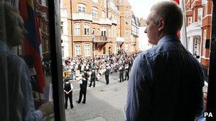 Julian Assange at the window of the Ecuadorean embassy
