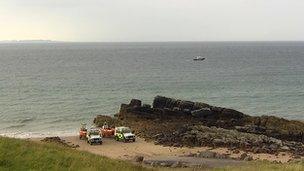Rescue vehicles and boats on shore at Gairloch