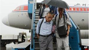 Sadao Masaki, left, arrives at the airport in Pyongyang, 28 August 2012