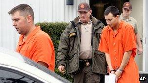 Anthony Peden (L), and Isaac Aguigui re led away after appearing before a magistrate judge at the Long County Sheriffs Office in Georgia, 12 December 2011