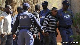 Police keep watch during the arrival of some of the mine workers, at a Garankuwa court outside Pretoria (20 August 2012)