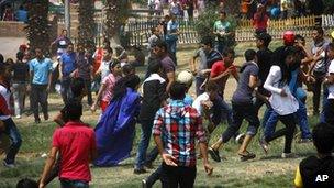 Egyptian women are harassed by a large crowd of men and boys in a park in Cairo. Photo: August 2012