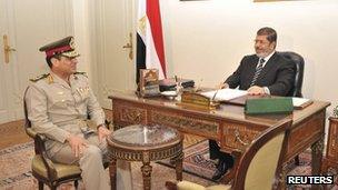 Egypt's President Mohamed Mursi meets with Defence Minister General Abdel Fattah al-Sisi in Cairo on 22 August