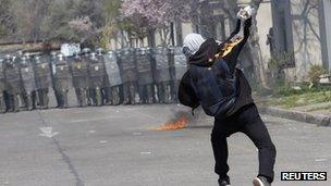 Demonstrator throws Molotov bomb at Chilean police