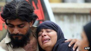 Relatives outside garment factory following a fire in Karachi, on September 12, 2012.