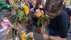 People lay flowers in memory of Hope Fennell