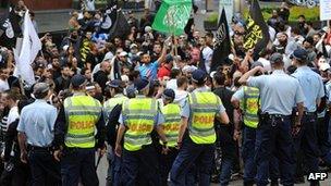 Police stand guard over protesters near the US Consulate General in central Sydney