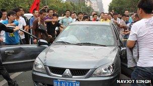 Protesters in the city of Xi'an set upon a Japanese-made car