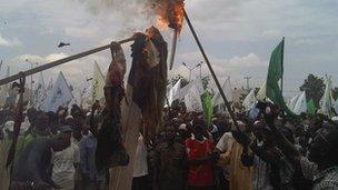 Demonstrators burn flags in Kano