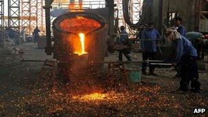 Afghan labourers work at the Kabul Foulad Steel plant in Herat