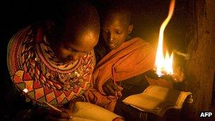 Children reading with naked light