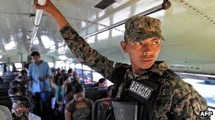 Honduran soldier riding a public bus in Tegucigalpa