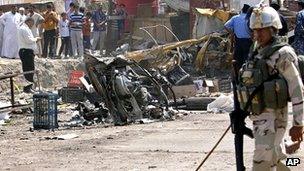 Security forces inspect the scene of a car bomb attack in Basra, 9 September 2012