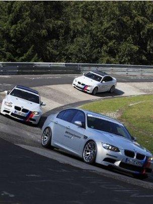 BMW models on a race track