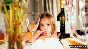 Girl among wine bottles