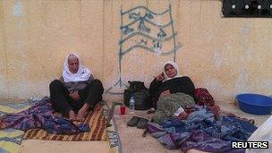 Displaced Syrians lying on makeshift beds