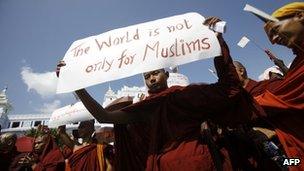 A Buddhist monk holds a sign as he takes part in a demonstration against the Organisation of the Islamic Conference - October 15, 2012.