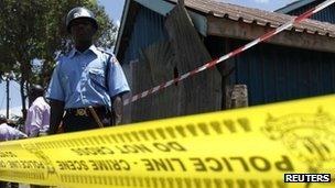 Policemen secure the scene of an explosion at the Anglican Church of Kenya Sunday school in the Kenyan capital Nairobi, September 30, 2012.